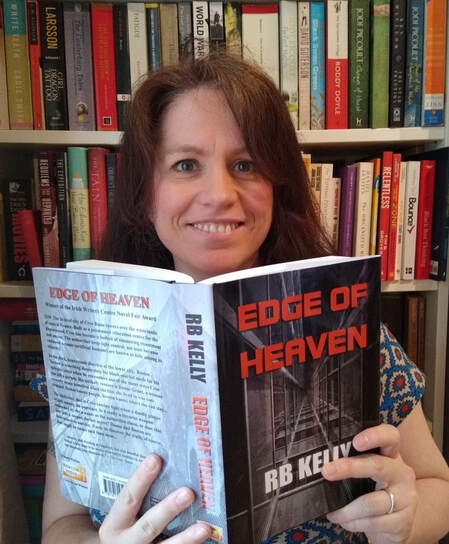 RB Kelly holding her novel Edge of Heaven